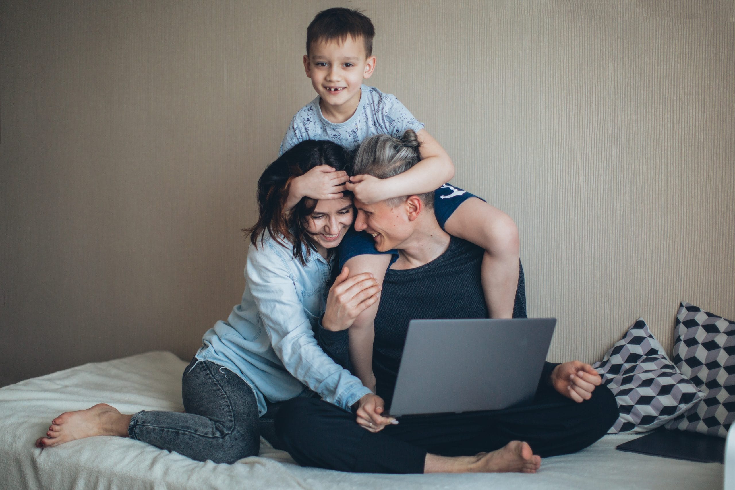 Man working remotely from home in Columbus, Ohio surrounded by his wife and young son.